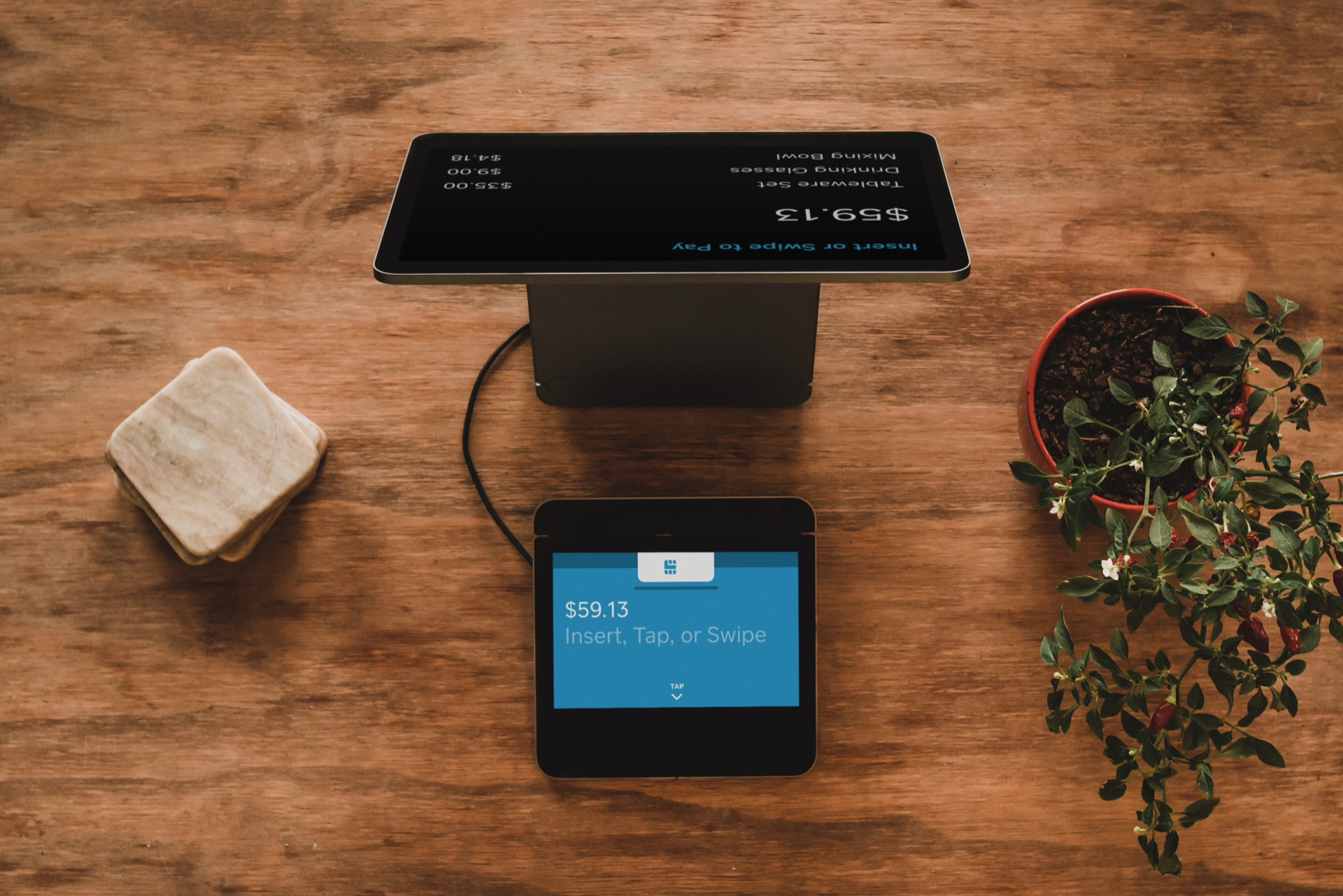 Point-of-sale terminal on a wooden table — bespoke retail software in action
